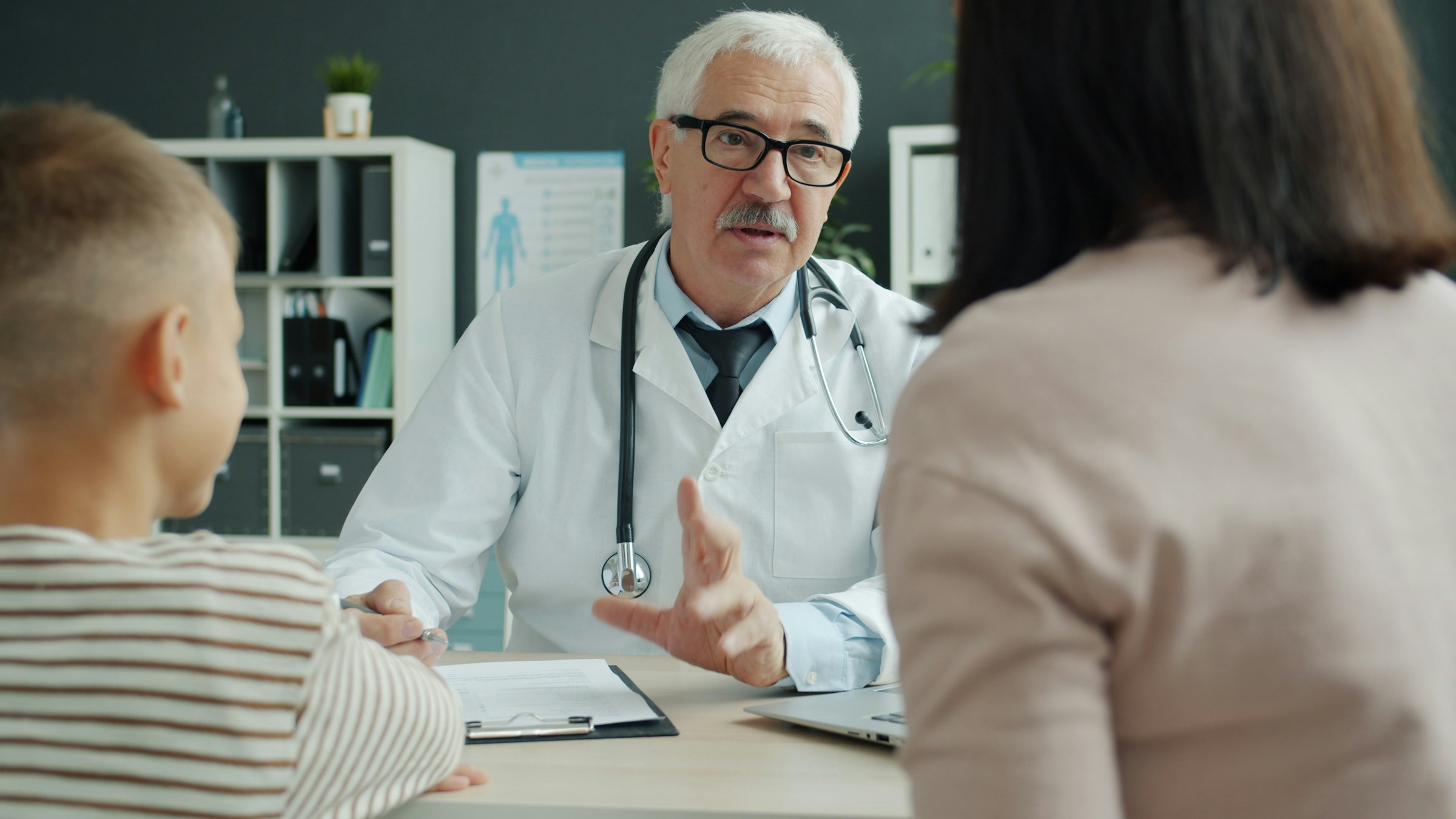 A doctor reviewing a treatment plan with a patient and their family